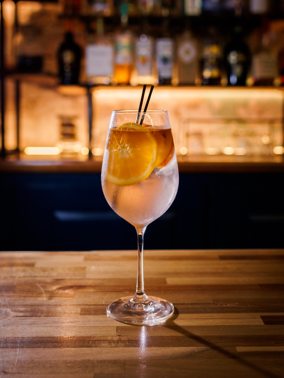 A citrus drink in warm bar light